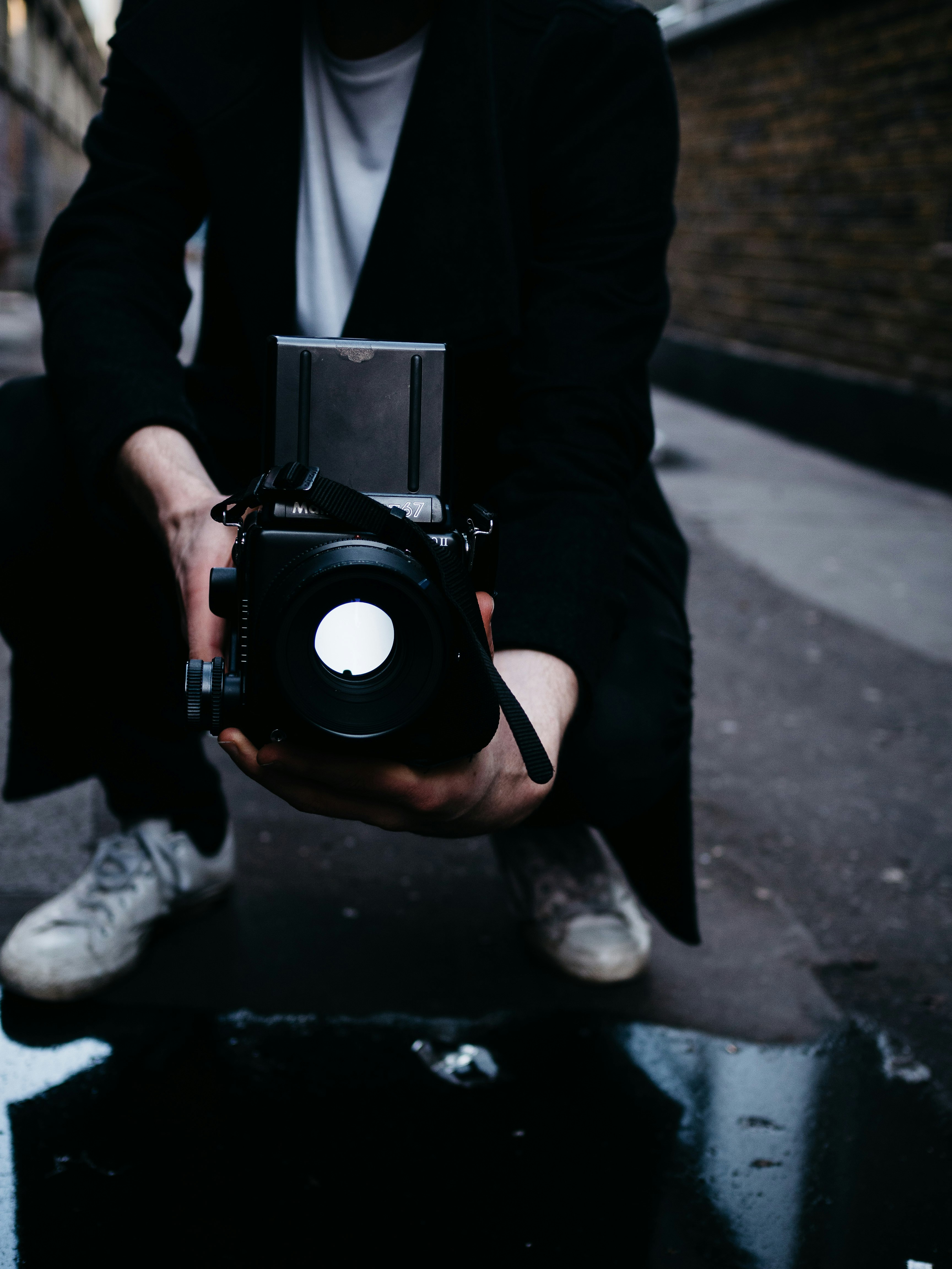 person holding black nikon dslr camera